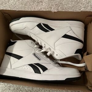 Women’s size 11 white and black sneakers.